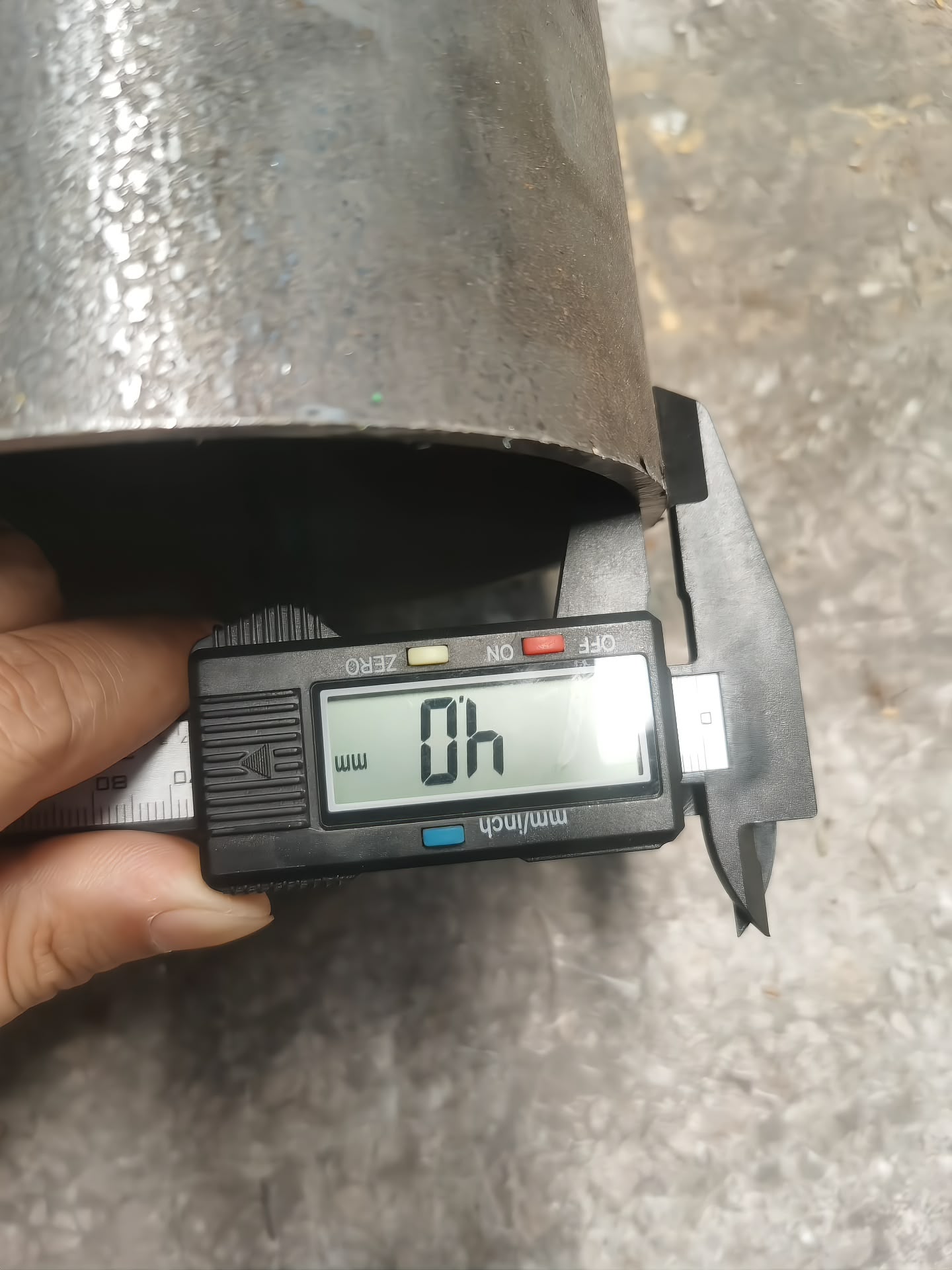 Incoming steel check — wall thickness verified at 4 mm with a digital caliper